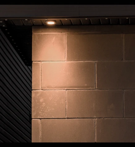Downlight inset from the corner and illuminating the face of a block wall