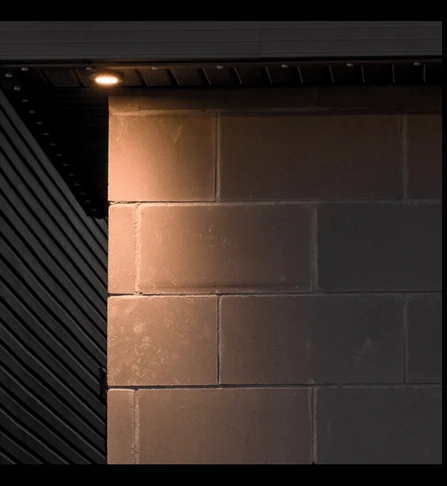Downlight mounted over the edge of a block wall corner