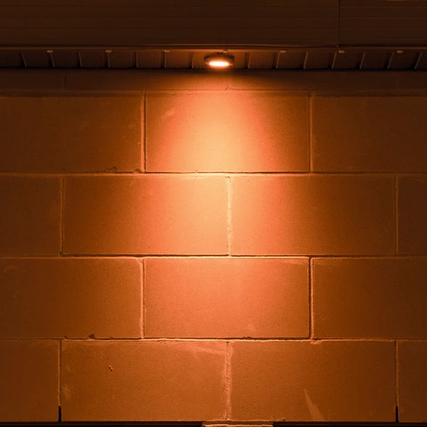 Downlight closer to a block wall casting a tighter pool of light